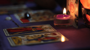 tarot cards on a table in front of a candle