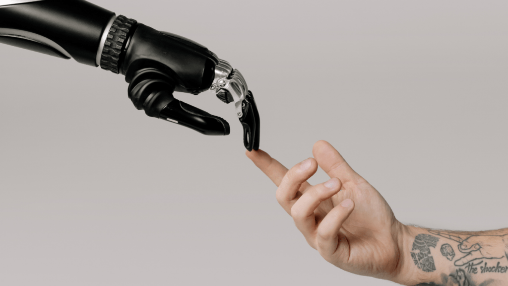 a robotic hand reaching out to touch a person's hand