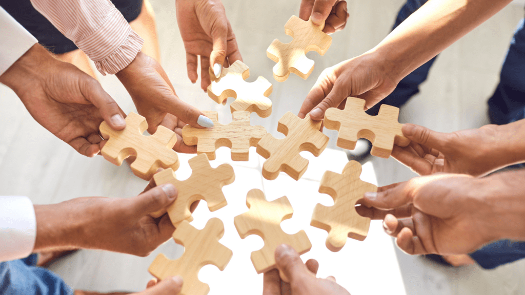 a group of people holding a jigsaw puzzle