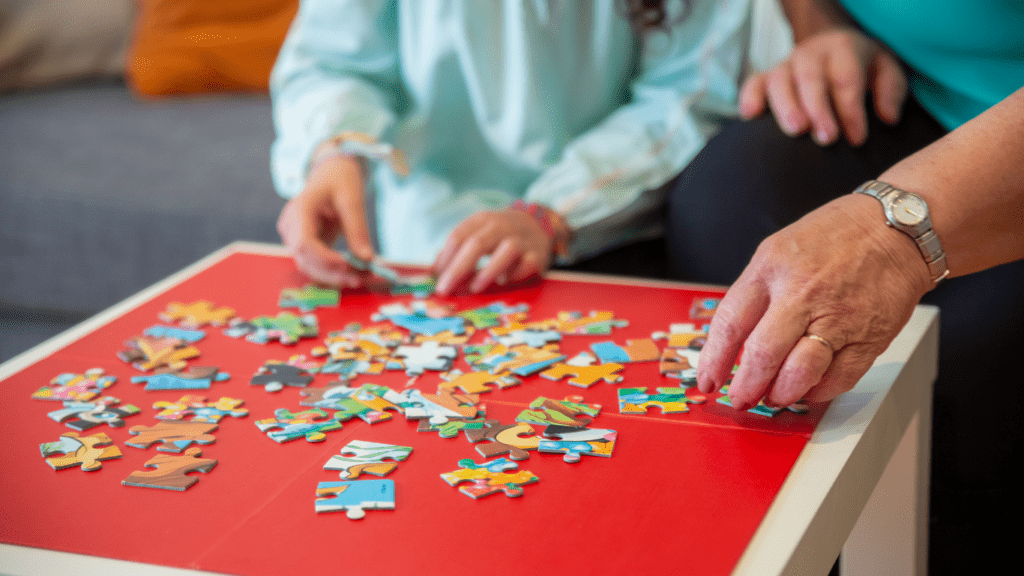 a group of people holding a jigsaw puzzle