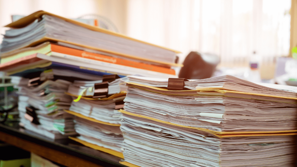 a stack of papers sitting on top of a desk