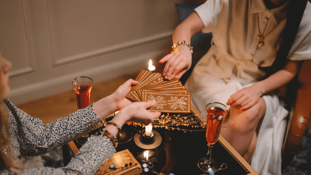 tarot cards on a table in front of a candle